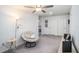 Cozy bedroom area with a comfy chair, a floor lamp, and soft carpeting at 32091 S Pop Ash N Pl, San Antonio, FL 33576