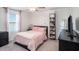 Cozy bedroom with ceiling fan, light pink bedding, and modern decor at 32091 S Pop Ash N Pl, San Antonio, FL 33576