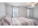 Bright bedroom features plush carpet, ceiling fan, and light pink bedding, creating a comfortable space at 32091 S Pop Ash N Pl, San Antonio, FL 33576
