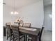 Formal dining room with a wooden table set beneath an elegant chandelier at 32091 S Pop Ash N Pl, San Antonio, FL 33576