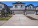 Charming townhome featuring a two-car garage and stone-accented columns enhancing its curb appeal at 32091 S Pop Ash N Pl, San Antonio, FL 33576