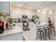 Beautiful white kitchen with stainless steel appliances, island with seating, and lots of storage at 32091 S Pop Ash N Pl, San Antonio, FL 33576