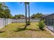 View of a fenced backyard, showing mature trees and a serene outdoor space at 3241 Brushwood Ct, Clearwater, FL 33761