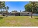 Spacious backyard with well-maintained lawn and perimeter fence, perfect for outdoor activities at 3241 Brushwood Ct, Clearwater, FL 33761