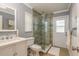 Bathroom featuring a glass shower, a white vanity, and a window at 3241 Brushwood Ct, Clearwater, FL 33761
