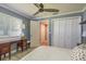 Bedroom featuring an antique writing desk and lots of closet space at 3241 Brushwood Ct, Clearwater, FL 33761