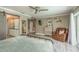 Bedroom features calming colors, wood floors, ceiling fan, and a comfortable reading chair at 3241 Brushwood Ct, Clearwater, FL 33761
