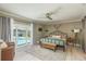 Bright bedroom with a view of the pool through sliding glass doors and ceiling fan at 3241 Brushwood Ct, Clearwater, FL 33761