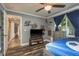 Comfortable bedroom with dark wood-look floors and blue curtains at 3241 Brushwood Ct, Clearwater, FL 33761