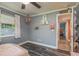 Bedroom with stylish floors, decorative shelves, ceiling fan, and an adjacent hallway at 3241 Brushwood Ct, Clearwater, FL 33761