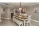 Elegant dining room features a farmhouse table and neutral décor at 3241 Brushwood Ct, Clearwater, FL 33761