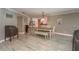 Dining room with gray paint, a view to the kitchen, and a white table with bench seating at 3241 Brushwood Ct, Clearwater, FL 33761