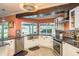 Bright kitchen with stainless steel appliances and a view of the screened in back porch at 3241 Brushwood Ct, Clearwater, FL 33761