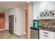 Kitchen with a wine rack, stainless steel fridge, and view of a wet bar at 3241 Brushwood Ct, Clearwater, FL 33761