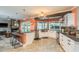 Kitchen featuring white cabinets, stainless appliances, mosaic backsplash and breakfast bar at 3241 Brushwood Ct, Clearwater, FL 33761