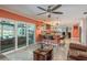 Open concept living room featuring a breakfast bar, patio access, and tile floors at 3241 Brushwood Ct, Clearwater, FL 33761