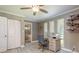 Office with great lighting, a modern desk, stylish shelves, and an adjacent bathroom at 3241 Brushwood Ct, Clearwater, FL 33761