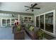 Covered patio with a comfortable outdoor sofa, a ceiling fan, and views of the pool at 3241 Brushwood Ct, Clearwater, FL 33761