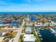 An aerial view of a waterfront community with canal access and the ocean visible in the distance at 3505 Seaway Dr, New Port Richey, FL 34652