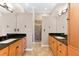 Large bathroom featuring and sinks with wood cabinets, black granite counters, and walk-in showers at 3505 Seaway Dr, New Port Richey, FL 34652