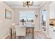 Dining room with a wood table, seating and a decorative chandelier at 3505 Seaway Dr, New Port Richey, FL 34652