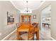 Well-lit dining room featuring a wooden table, hutch and a view into the game room at 3505 Seaway Dr, New Port Richey, FL 34652