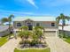 Stunning two-story waterfront home with two-car garage, front palms, and a beautiful landscape design at 3505 Seaway Dr, New Port Richey, FL 34652