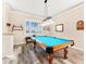 Game room featuring a pool table under pendant lighting and a window with plantation shutters at 3505 Seaway Dr, New Port Richey, FL 34652