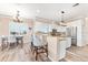 Kitchen featuring stainless appliances, white cabinets, granite counters, and bar seating at 3505 Seaway Dr, New Port Richey, FL 34652