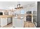 Bright kitchen featuring stainless appliances, white cabinets, and a center island at 3505 Seaway Dr, New Port Richey, FL 34652