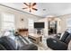 Spacious living room with a ceiling fan, a large flat-screen television, and comfortable leather seating at 3505 Seaway Dr, New Port Richey, FL 34652