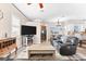 Inviting living room featuring hardwood floors, a ceiling fan, and comfortable black leather seating at 3505 Seaway Dr, New Port Richey, FL 34652