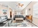 Bright living room with hardwood floors, a ceiling fan, and comfy black leather sofas at 3505 Seaway Dr, New Port Richey, FL 34652