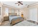 Comfortable bedroom featuring neutral colors, plantation shutters and ensuite access at 3505 Seaway Dr, New Port Richey, FL 34652