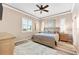 Inviting main bedroom featuring a ceiling fan and plantation shutters for plenty of natural light at 3505 Seaway Dr, New Port Richey, FL 34652