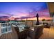Enjoy the sunset and canal views on the rooftop deck with a bar and lounge furniture at 3505 Seaway Dr, New Port Richey, FL 34652