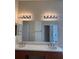 Bathroom featuring double sinks with updated fixtures and a large mirror at 446 Noble Faire Dr, Sun City Center, FL 33573