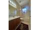 Well-lit bathroom featuring vanity, tile flooring, tub, shower, and a decorative window at 446 Noble Faire Dr, Sun City Center, FL 33573