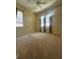 Bright bedroom with carpet floors, natural light and a ceiling fan for comfort at 446 Noble Faire Dr, Sun City Center, FL 33573