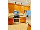 A spacious kitchen featuring stainless steel appliances and wooden cabinets at 446 Noble Faire Dr, Sun City Center, FL 33573