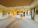 Spacious open-plan living room with high ceilings flowing into the kitchen area, ideal for entertaining at 446 Noble Faire Dr, Sun City Center, FL 33573