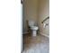 Compact half bathroom with a toilet, grab bar, and tiled flooring at 446 Noble Faire Dr, Sun City Center, FL 33573
