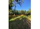 Spacious grassy backyard with a wood fence, perfect for outdoor activities and relaxation at 4504 Cabbage Palm Dr, Valrico, FL 33596