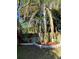 Landscaped backyard featuring a wood fence, landscaping, and mature palm trees at 4504 Cabbage Palm Dr, Valrico, FL 33596