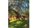 Landscaped backyard featuring a wood fence and vibrant tropical foliage for enhanced privacy and appeal at 4504 Cabbage Palm Dr, Valrico, FL 33596