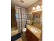 Traditional bathroom featuring a shower-tub combo, granite vanity, and plenty of bright light at 4504 Cabbage Palm Dr, Valrico, FL 33596