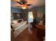This is a cozy bedroom with a daybed, ceiling fan, and natural light from the window at 4504 Cabbage Palm Dr, Valrico, FL 33596
