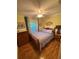 Bright bedroom features hardwood floors, sunny yellow walls, a ceiling fan, and traditional furniture at 4504 Cabbage Palm Dr, Valrico, FL 33596