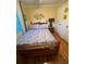 A fully furnished bedroom showcasing hardwood floors, a ceiling fan, and ample natural light at 4504 Cabbage Palm Dr, Valrico, FL 33596