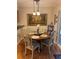 Intimate dining room with wood floors, a round table with four chairs, and natural light coming from a sliding glass door at 4504 Cabbage Palm Dr, Valrico, FL 33596